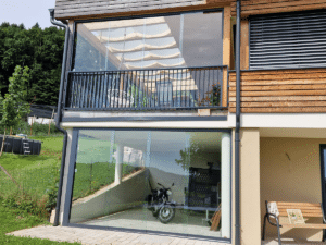 Glasschiebewand auf Balkon und für Terrasse in Garten mit Hanglage